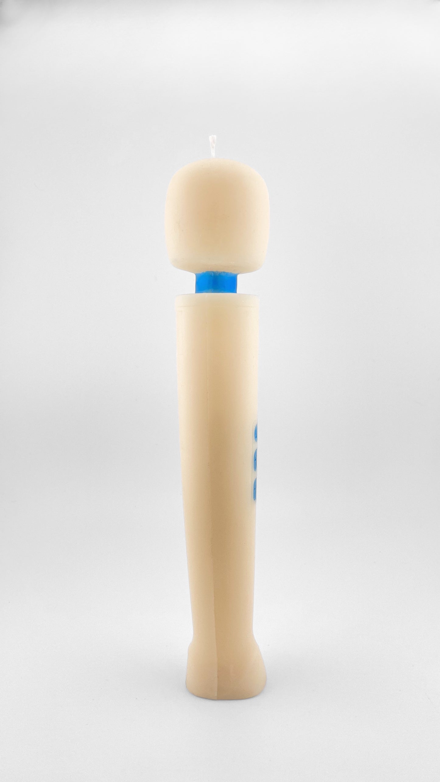 A novelty vibrator candle made of off-white soy wax with a blue accents resembling the iconic Magic Wand vibrator, standing upright on a light gray background.